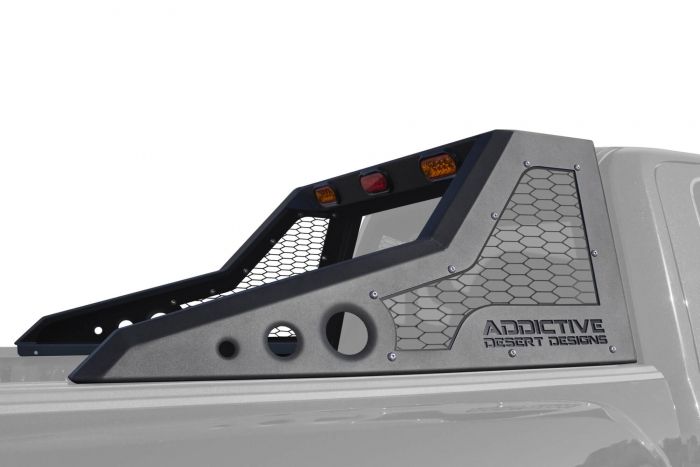 Off-road truck features a rugged headache rack with hex mesh panel and integrated lighting, mounted securely with reinforced side rails.